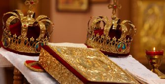 weddings crowns stand on a table near a gospel
in an orthodox church